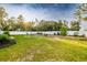 A sprawling backyard offers a serene escape, with a well-manicured lawn, mature trees, and a private fence, perfect for relaxation at 3897 Sw 169Th Lane Rd, Ocala, FL 34473