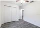 Bedroom featuring double closets and gray wood flooring at 3897 Sw 169Th Lane Rd, Ocala, FL 34473