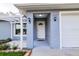 Inviting covered front entrance with sidelight sconces at 3897 Sw 169Th Lane Rd, Ocala, FL 34473