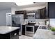 Modern kitchen featuring stainless steel appliances, center island, and granite countertops at 3897 Sw 169Th Lane Rd, Ocala, FL 34473