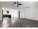 Open-concept living room featuring modern gray wood flooring and lots of natural light at 3897 Sw 169Th Lane Rd, Ocala, FL 34473