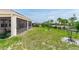 Spacious backyard with well-manicured lawn, screened in patio, and perimeter fencing at 5248 Red Coral Cir, Mount Dora, FL 32757