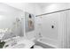 Bright, white bathroom with modern fixtures, a bathtub and minimalist decor at 5248 Red Coral Cir, Mount Dora, FL 32757