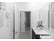 Hallway view towards a bathroom featuring modern fixtures and decor, leading to another room at 5248 Red Coral Cir, Mount Dora, FL 32757
