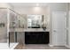 Modern bathroom featuring a glass-enclosed shower and a sleek black vanity with double sinks at 5248 Red Coral Cir, Mount Dora, FL 32757