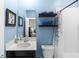 Well-lit bathroom with blue walls and a shower-tub combination at 5248 Red Coral Cir, Mount Dora, FL 32757