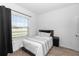 Cozy bedroom with modern decor, a comfortable bed, and a large window at 5248 Red Coral Cir, Mount Dora, FL 32757