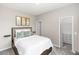 Comfortable bedroom with neutral decor and a view to the walk-in closet at 5248 Red Coral Cir, Mount Dora, FL 32757