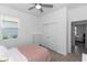 Bright bedroom with a ceiling fan, closet, and large window at 5248 Red Coral Cir, Mount Dora, FL 32757