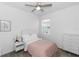 Comfortable bedroom with a pink bedspread, modern furniture, and a serene atmosphere at 5248 Red Coral Cir, Mount Dora, FL 32757