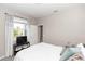 Cozy bedroom featuring a large window with decorative curtains at 5248 Red Coral Cir, Mount Dora, FL 32757