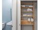 Organized closet with wooden shelving offering efficient storage for linens at 5248 Red Coral Cir, Mount Dora, FL 32757