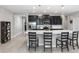 Bright kitchen featuring a large island with seating, stainless steel appliances, and sleek, dark cabinets at 5248 Red Coral Cir, Mount Dora, FL 32757