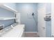 Modern laundry room with washer, dryer, shelving, and a stylish decor at 5248 Red Coral Cir, Mount Dora, FL 32757
