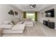 Bright living room with a large sectional sofa and view of the backyard, perfect for relaxing and entertaining guests at 5248 Red Coral Cir, Mount Dora, FL 32757