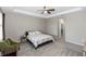 Spacious main bedroom featuring a ceiling fan, carpet, and an ensuite bathroom at 5248 Red Coral Cir, Mount Dora, FL 32757