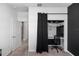 Bedroom closet converted to office nook with sleek black furniture and privacy curtain at 5248 Red Coral Cir, Mount Dora, FL 32757