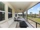 Covered patio with outdoor furniture, ceiling fan, and view of the landscaped backyard at 5248 Red Coral Cir, Mount Dora, FL 32757