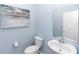 Stylish powder room with elegant vanity, mirror, and decor at 5248 Red Coral Cir, Mount Dora, FL 32757