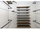 Large walk-in closet featuring custom wood shelving and metal rods at 5248 Red Coral Cir, Mount Dora, FL 32757