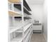 Walk-in closet with custom shelving, drawers, and ample storage space for organized and accessible clothing at 5248 Red Coral Cir, Mount Dora, FL 32757