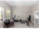 Home gym setup with workout equipment and natural light from two windows at 5248 Red Coral Cir, Mount Dora, FL 32757
