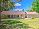 Backyard view showing the screen patio and the exterior of the home at 5410 Nw 62Nd Ave, Ocala, FL 34482
