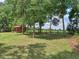 Expansive backyard features mature trees, lush green lawn, fencing, and a storage building at 5410 Nw 62Nd Ave, Ocala, FL 34482