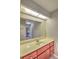 Bright bathroom featuring a large mirror and wooden vanity at 5410 Nw 62Nd Ave, Ocala, FL 34482