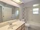 Bathroom with large mirror above vanity, toilet and bathtub at 5410 Nw 62Nd Ave, Ocala, FL 34482