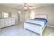 Bright bedroom featuring gray floors, a ceiling fan, and furniture set at 5410 Nw 62Nd Ave, Ocala, FL 34482