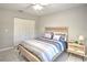 Bedroom featuring gray floors, ceiling fan, closet, and a double bed at 5410 Nw 62Nd Ave, Ocala, FL 34482