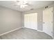 Bedroom with a ceiling fan, closet and gray flooring at 5410 Nw 62Nd Ave, Ocala, FL 34482