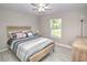 Bedroom with gray floors, ceiling fan, window, and bed at 5410 Nw 62Nd Ave, Ocala, FL 34482