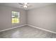 Bedroom featuring light gray walls, gray floors, and a window at 5410 Nw 62Nd Ave, Ocala, FL 34482