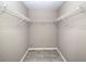 Walk-in closet featuring overhead shelving and gray flooring at 5410 Nw 62Nd Ave, Ocala, FL 34482
