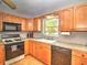 Functional kitchen featuring oak cabinets and modern appliances at 5410 Nw 62Nd Ave, Ocala, FL 34482