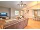 Cozy living room featuring vaulted ceilings, wood floors, and a comfortable seating area at 5410 Nw 62Nd Ave, Ocala, FL 34482