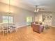 Spacious living room with dining area, vaulted ceilings, and a built-in bookcase providing ample storage at 5410 Nw 62Nd Ave, Ocala, FL 34482