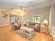 Inviting living room with comfortable seating, wood floors, and natural light creating a cozy atmosphere at 5410 Nw 62Nd Ave, Ocala, FL 34482