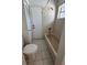 Compact bathroom featuring a tiled shower-tub combo and toilet at 5525 Se 43Rd Ct, Ocala, FL 34480