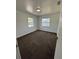 Bright bedroom features neutral paint, plush carpet, and natural light from two windows at 5525 Se 43Rd Ct, Ocala, FL 34480