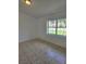 Bright bedroom featuring neutral walls, a large window, and ceramic tile floors at 5525 Se 43Rd Ct, Ocala, FL 34480