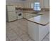 Classic kitchen featuring white cabinets, tile backsplash, and modern appliances at 5525 Se 43Rd Ct, Ocala, FL 34480
