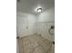 Functional laundry room with tile floor and a door at 5525 Se 43Rd Ct, Ocala, FL 34480