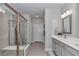 Elegant bathroom featuring double vanity sinks, a soaking tub, and glass shower doors at 5634 Sw 91St Ave, Ocala, FL 34481