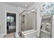 Bright bathroom featuring a glass shower enclosure, neutral tile, and stylish decor at 5634 Sw 91St Ave, Ocala, FL 34481