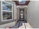 Close-up of a home's front entrance with a glass front door and stone pathway at 5634 Sw 91St Ave, Ocala, FL 34481