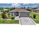 Charming single-story home with a well-manicured lawn and a gray two-car garage at 5634 Sw 91St Ave, Ocala, FL 34481