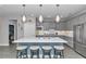 Well-equipped kitchen features an island with bar stool seating and modern stainless steel appliances at 5634 Sw 91St Ave, Ocala, FL 34481